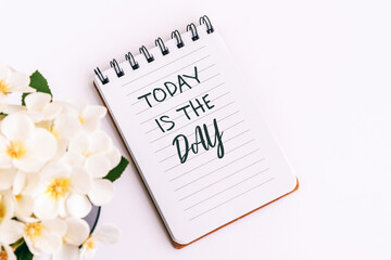 Inspiration quotes - Today is the day. Notepad and flower.