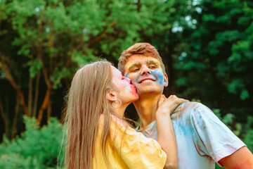 Wall Mural - young pretty couple having fun at holi fest