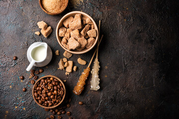 Wall Mural - Ingredients for coffee drinks. Bowls of brown cane lump and granulated sugar, crystal sugar sticks, milk and coffee beans