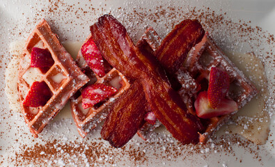 Wall Mural - French toast. Classic American restaurant breakfast or brunch favorite. Brioche toast fried in butter and served with strawberries, blackberries, whipped cream powdered sugar and maple syrup.