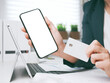 © eplisterra - Smartphone mockup for online shopping, booking and banking concept. young woman holding credit card and using laptop and smartphone. Businesswoman or entrepreneur in the home office