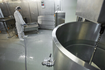 High angle background image of female worker washing equipment at clean food production factory, copy space