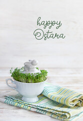 Wall Mural - happy Ostara. Easter bunny with fresh cress salad in cup on table.  Easter holiday. spring festive season. table decorations. wicca pagan tradition. spring equinox holiday