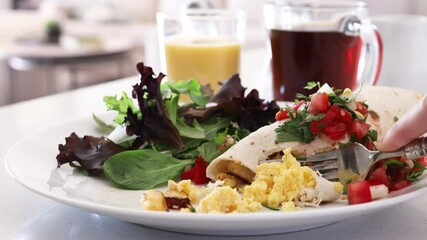 Canvas Print - Eating Breakfast Burrito with Eggs and Potatoes