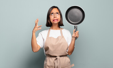 Canvas Print - young hispanic woman screaming with hands up in the air, feeling furious, frustrated, stressed and upset