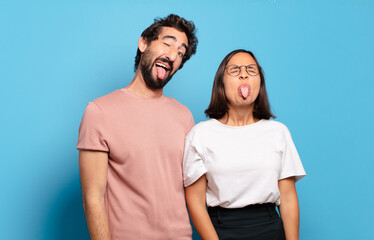 Sticker - young couple with cheerful, carefree, rebellious attitude, joking and sticking tongue out, having fun