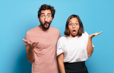 Canvas Print - young couple open-mouthed and amazed, shocked and astonished with an unbelievable surprise