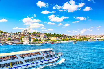 touristic sightseeing ships in golden horn bay of istanbul and view on suleymaniye mosque with sulta