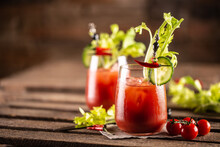 Bloody Or Virgin Mary Cocktail Served In A Cup With Celery Sticks And Cherry Tomatoes