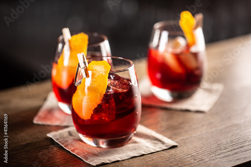 Negroni classic cocktail and gin short drink with sweet vermouth, red bitter liqueur and dried orange garnish © weyo