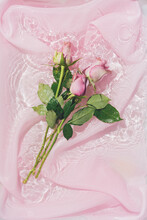 Pink Rose Flower Bouquet In Water With Silk Fabric. Valentines Or Woman's Day Background Design. Minimal Flat Lay Nature.