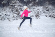 © nuzza11 - A woman runs in the snow in the winter mountains. Sports, fitness - inspiration and motivation. Woman jogging outdoors. High quality photo.