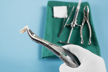 Wall Mural -  Dentistry medical tools forcept on blue background.