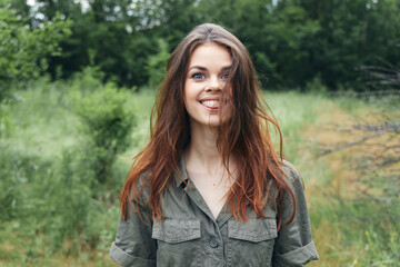 woman smile green jumpsuit nature trees meadow 