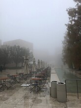 Scenic View Of Tables And Chairs In Mist