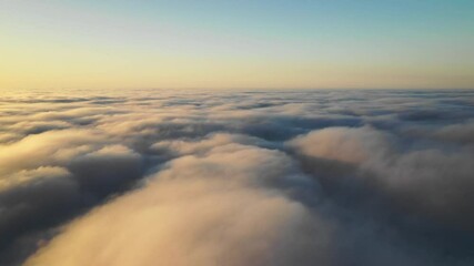 Wall Mural - striking aerial view of the sunset sky with the clouds below us. the shadows projected from the sun 