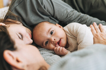 real family of young mom and two kids of different ages teenager girl and baby boy having fun on the