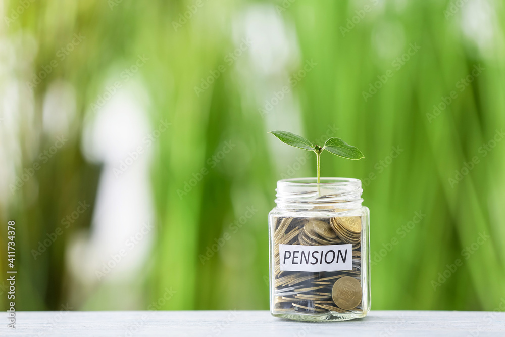 Jar with savings and young plant on table outdoors. Concept of pension