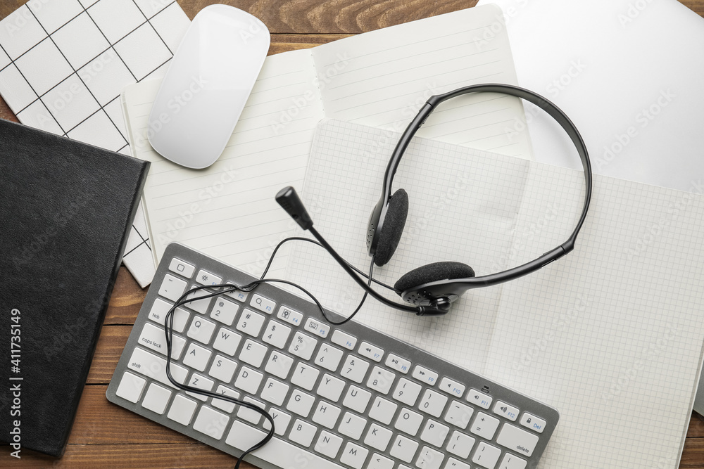 Headset with computer and notebooks on table