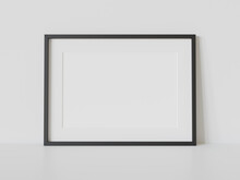 Black Frame Leaning On White Floor In Interior Mockup. Template Of A Picture Framed On A Wall 3D Rendering