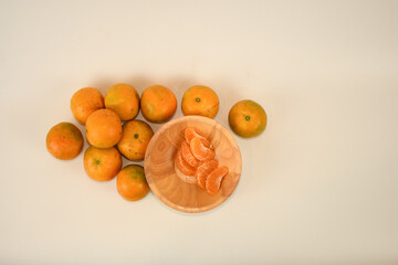 top view fresh sweet orange with pulp in wooden bowl on white background