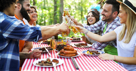 Friends making barbecue and having lunch in the nature