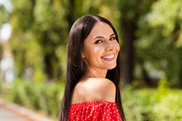 Poster - Side profile photo portrait of cheerful woman smiling wearing stylish red dress with off-shoulders laughing on green streets