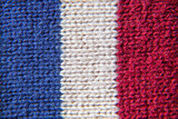 Fototapeta Młodzieżowe - knitted material close-up with stripes of flowers blue white red