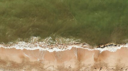 Wall Mural - Aerial view of the sandy beach and sea waves. Vacation at sea