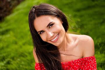 Poster - Photo of adorable shiny young lady wear red off-shoulders dress sitting green grass relaxing outside countryside