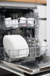 © Владислав Легір - Open dishwasher with clean dishes in the white kitchen