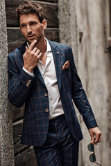 Wall Mural - Handsome man in classik checked suit thinking
