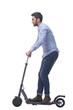 © ASDF - side view. attractive young man with an electric scooter.