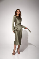 Beauty brunette woman luxury lifestyle bright makeup wear natural organic silk midi dress high heels perfect body shape fashion model style for meeting party or romantic date studio grey background.