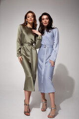 two sexy brunette woman luxury lifestyle bright makeup wear natural organic silk midi dress and high