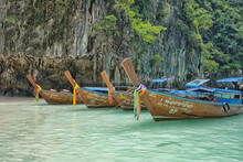 Boats On The Beach In A Blue Lagoon In Thailand