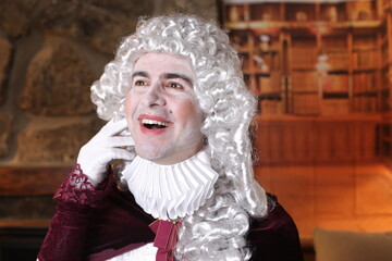 Baroque man smiling in classic  library