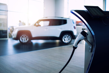 Car dealership selling electric car and charger in showroom.