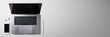 © Halfpoint - Flat lay top view office desk working space with laptop on gray background. Copy space.