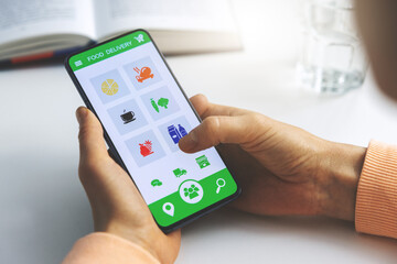 woman using mobile phone app to order food delivery