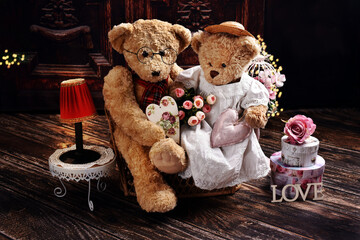 a couple of vintage style teddy bears sitting on sofa on Valentines Day