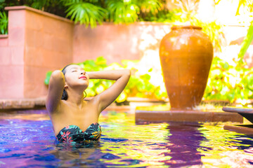 Portrait beautiful young asian woman relax smile enjoy leisure around swimming pool