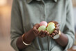© Seventyfour - Close up of unrecognizable African-American woman holding pastel colored easter eggs , focus on female hands, copy space