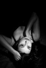 Portrait Of A Beauty Woman In Black And White. Black Long Hair Turkish Woman Laying On A Floor