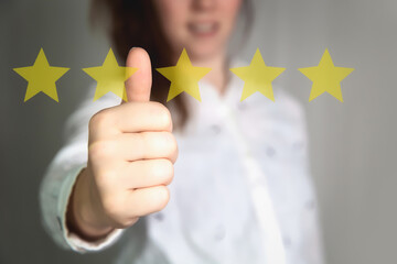 Customer Experience Concept. Woman hand showing on five star excellent rating on background, copy space Female with thumbs up