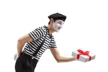 Wall Mural - Profile shot of a mime giving a gift box