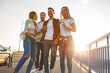 Group of friends hangout at the city street.They walking over the bridge and joying in sunset.