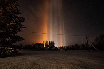 Wall Mural - Light Pillars result from a rare meteorological phenomena. Winter nature landscape.
