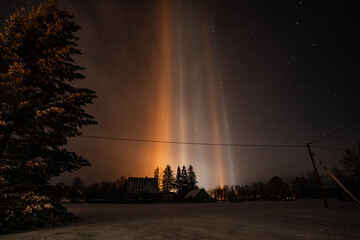 Wall Mural - Light Pillars result from a rare meteorological phenomena. Winter nature landscape.
