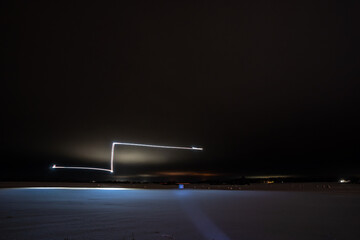 light painting with drone at cold winter night night. Winter landscape.